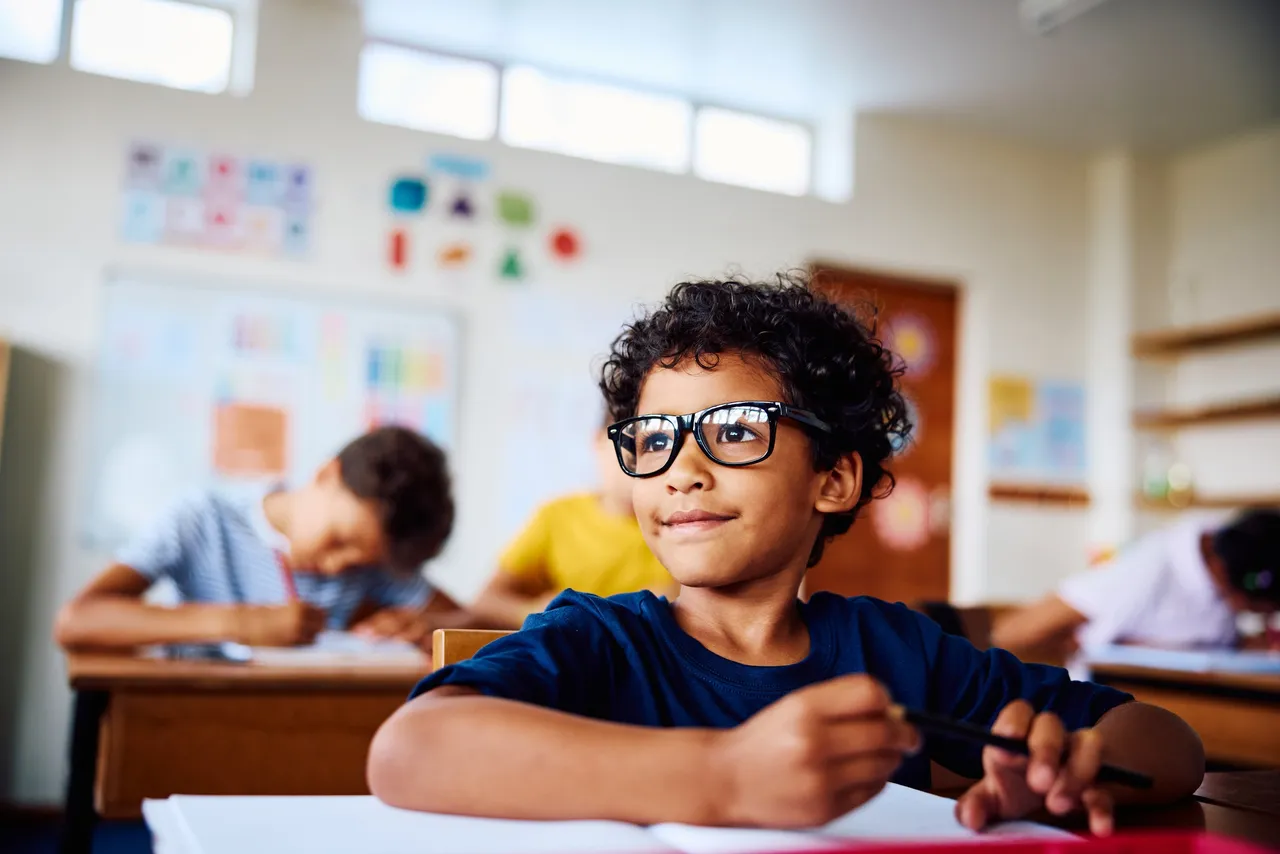 Child wearing glasses in school