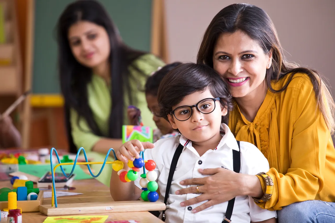 Smiling woman with child at school