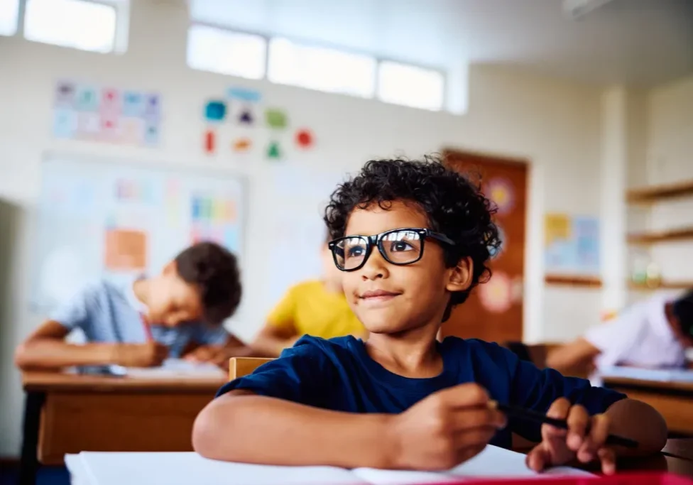 Child wearing glasses in school